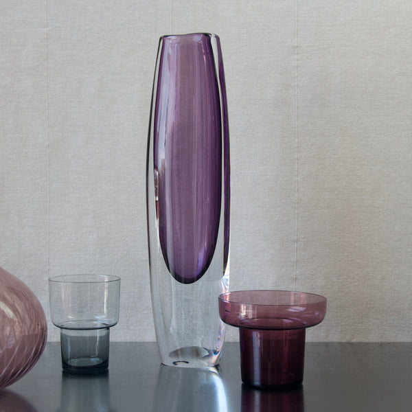 Group image of Modernist Scandinavian glass objects including Gunnar Nylund Strombergshyttan vase, Lisa Pape Iittala vase and Nanny Still purple vase