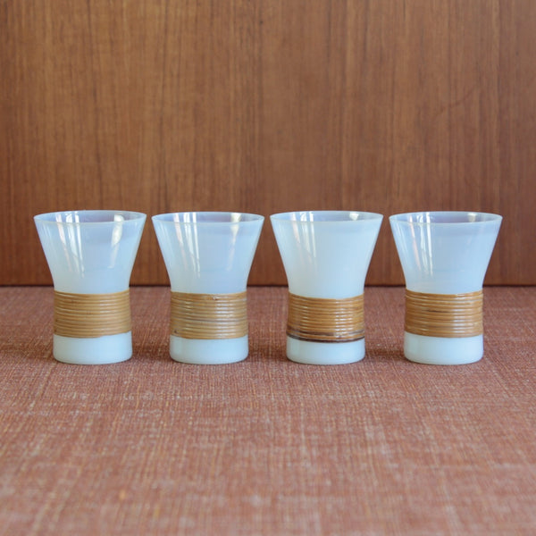 Four Jacob Bang Kastrup Glassworks Opaline drinking glasses stood in a line. The design blends utility and art in a way that still resonates with collectors of Danish Modern glass.