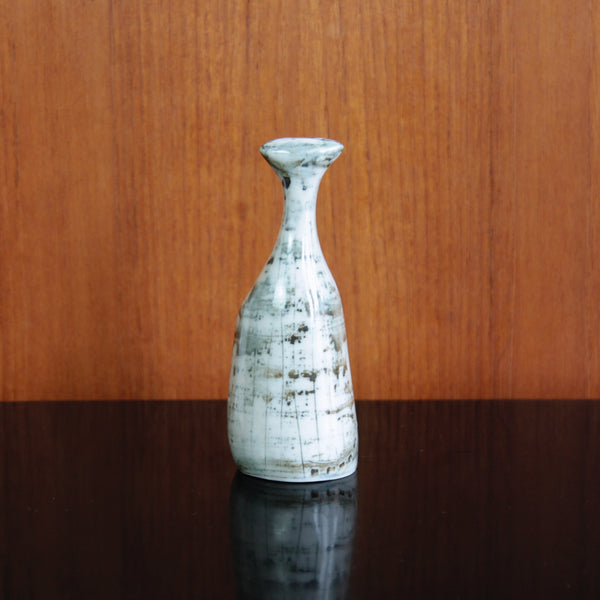 Reverse or back of a gloss-glaze porcelain cat ornament, capturing playful elegance and Modernist sophistication.