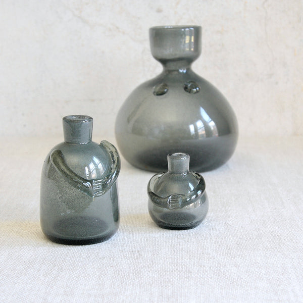 Group shot of 3 Post-war Swedish art glass bottle-vases by Erik Höglund, combining sculptural presence and functionality -the vessels are intended to be used as vases and/or candlestick.