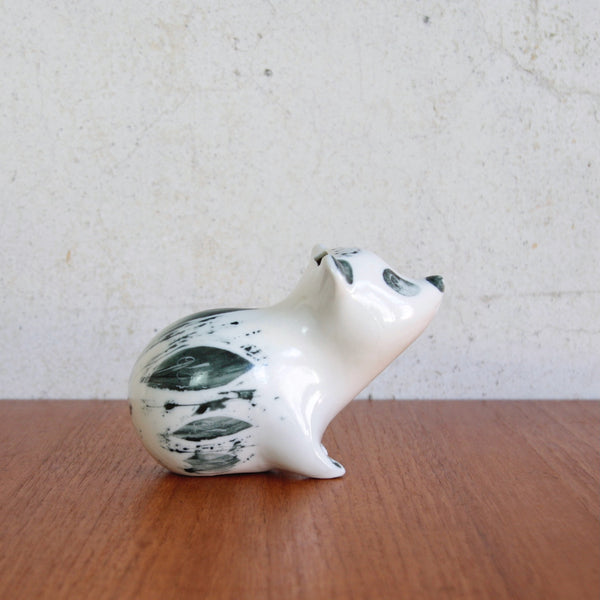 Side view of a wax resist and sgraffito-decorated porcelain bear by Susan Parkinson, for sale in the UK from Art & Utility.