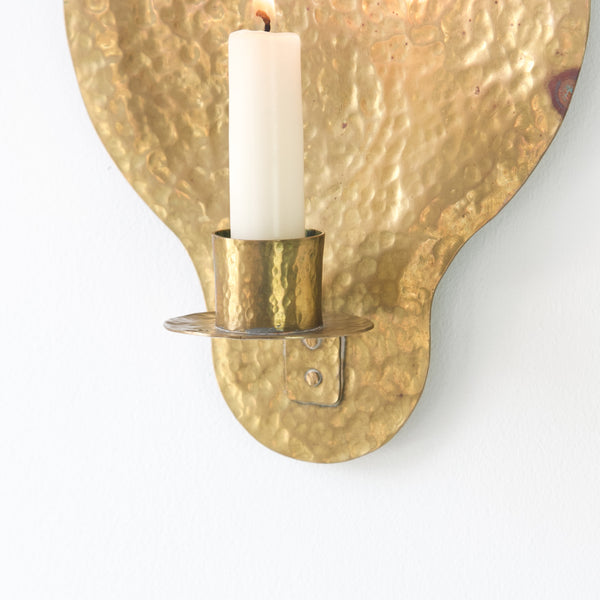 Naïvely crafted brass wall sconce from Sweden, evoking charm and character.