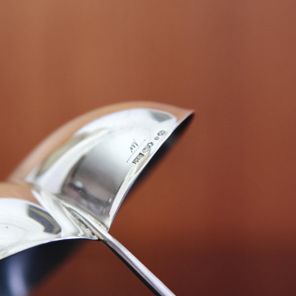 Close up showing the stamped makers marks on a vintage Finnish silver bon bon dish by Tapio Wirkkala, inspired by natural leaf forms.