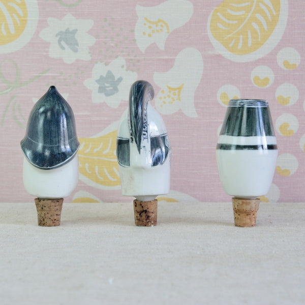 Three decorative ceramic bottle stoppers with cork bases. Hand-decorated porcelain top. This trio were designed by Susan Parkinson and Guy Neale, created at the Parkinson Pottery in Kent during the 1950s.