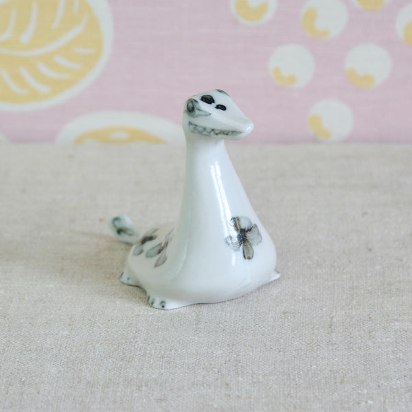 Susan Parkinson porcelain Nessie with freely painted curls, incised markings and decorative floral motif