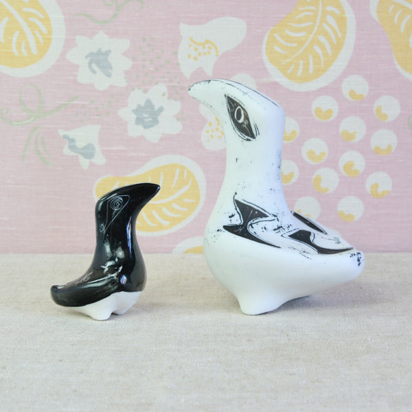 Playful mood image showing two 1950s Modernist animal figures. Both items are porcelain Toucans by Susan Parkinson. The small black example came first, and later Susan Parkinson enlarged the design, seen on the right. 