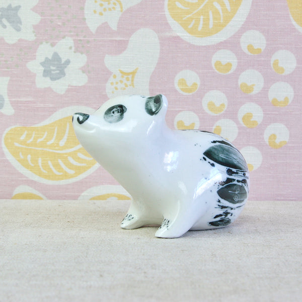 A large glossy porcelain money box in the form of a seated panda bear designed by Susan Parkinson circa 1952.
