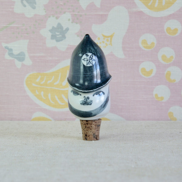 Susan Parkinson Policeman porcelain bottle stopper, circa 1955, with a characterful hand-painted face and traditional British police helmet.