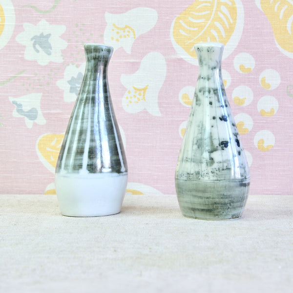 A pair of tall and slender ceramic salt and pepper pots. This salt & pepper set is the earliest of three slip-cast porcelain cruets designed by Susan Parkinson. The duo's sleek and organic form is not only elegant and ergonomic, but perfectly represents Britain's Modernist aesthetic of the mid-1950's.