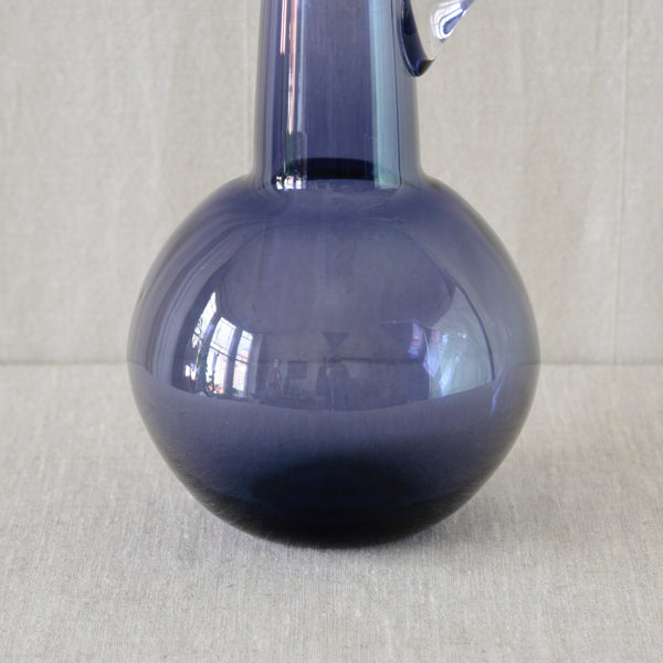Spherical body of a handmade lilac glass carafe by Tamara Aladin for Riihimäki, Finland, with a dramatic geometric silhouette dating from 1960.