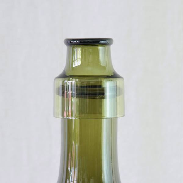 Tapio Wirkkala model 2508 Rengaskaula bottle for Iittala, with matching 2008 wine glass. Designed in 1959 in a rich olive green glass.