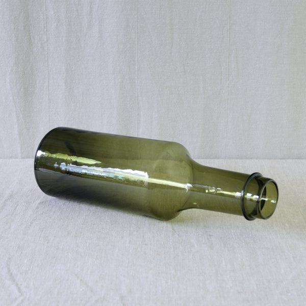 Tapio Wirkkala model 2507 glass bottle, designed for Iittala Finland in 1959 and produced in a rich olive green colour.