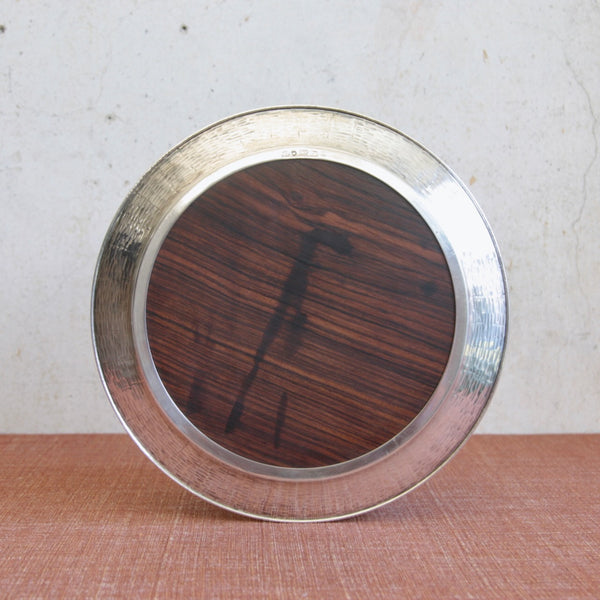 Head on view of the backside of a luxury Scandinavian serving tray by Tapio Wirkkala combining solid silver and macassar ebony