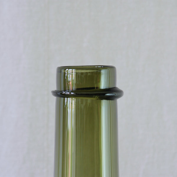 Detail image of olive green glass bottle by Tapio Wirkkala for Iittala.