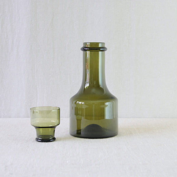 Tapio Wirkkala models 2508 and 2008 for Iittala, comprising an olive green Rengaskaula bottle with its matching wine glass.