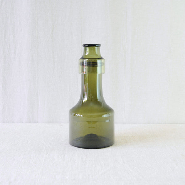 Tapio Wirkkala Rengaskaula in rich olive green glass, designed for Iittala in 1959 with an archaic yet distinctly Modernist character. The 2008 wine glass sits on top.