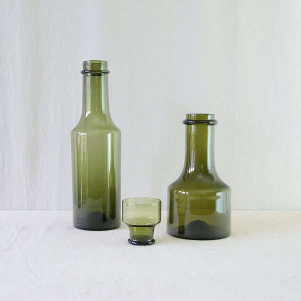 Group of Tapio Wirkkala olive green glass 'Rengaskaula' bottles, 1959, Iittala, Finland. Available to buy at Art & Utility.