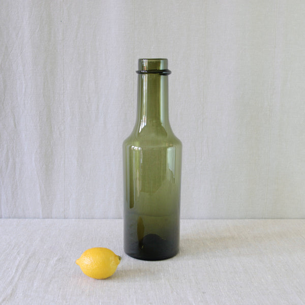 Tapio Wirkkala Rengaskaula bottle in olive green glass, an elegant example of the designer’s less common work in coloured Finnish glass.