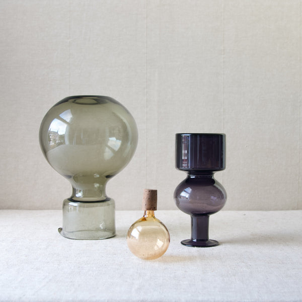 A photo showing the three parts of a Top half of a Model KF 500, KF 1500 'Kremlin Kellot' or 'Kremlin Bells' decanter stood upside down. The design is by Kaj Franck, one of the twentieth century’s most renowned and highly influential and collected glass designers.