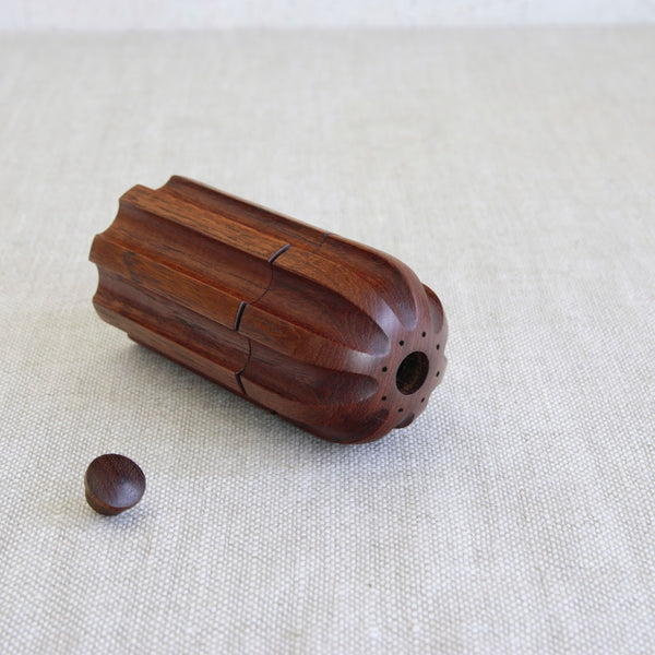 Top down shot of a pepper mill laying on its side. Transitional period Danish made "Bullet" mill designed by Jens Quistgaard.