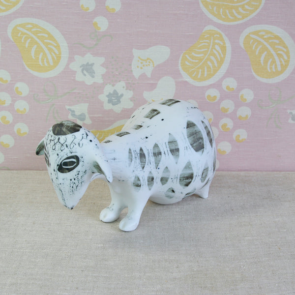 Top down shot of a Susan Parkinson Pregnant Sheep, a collectable 1950s porcelain sculpture in black & white with elaborate wax-resist decoration