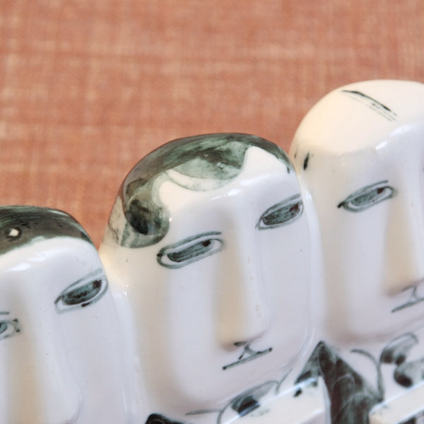 Detail from above of commuters in a Post-war English Modernist porcelain sculpture by Susan Parkinson. The mid-century work is called 'The 8:15'.