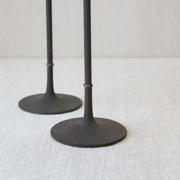 Detail of the elegantly conical shaped organic modern feet on a pair of Jens Quistgaard candlesticks, by Dansk.