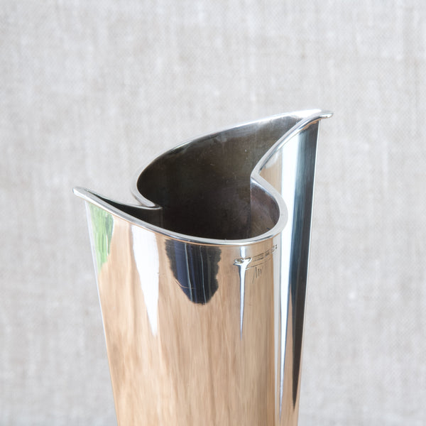 Top down view of an interestingly shaped silver metal vase designed by Tapio Wirkkala for Kultakeskus Oy. This vase is often referred to as the "Flame".