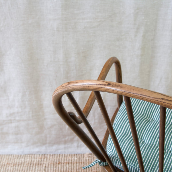 Invest in a rare Danish Windsor chair by Niels Eilersen, boasting modernist Scandinavian design aesthetics.