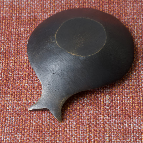 Large image of the reverse of a Walter Bosse fish shaped dish made by Herta Baller. The fine tool file marks and light but characterful black patination are tell tale signs of Herta Ballers expert brass making skills.