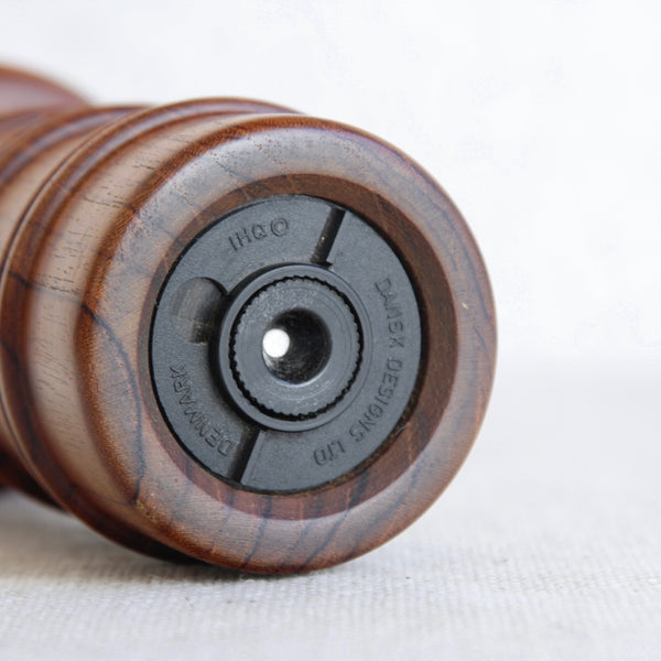 Underside of a Nordic mid-century teak pepper grinder by Jens Quistgaard. Item fully stamped Dansk Designs Ltd, Denmark, IHQ.