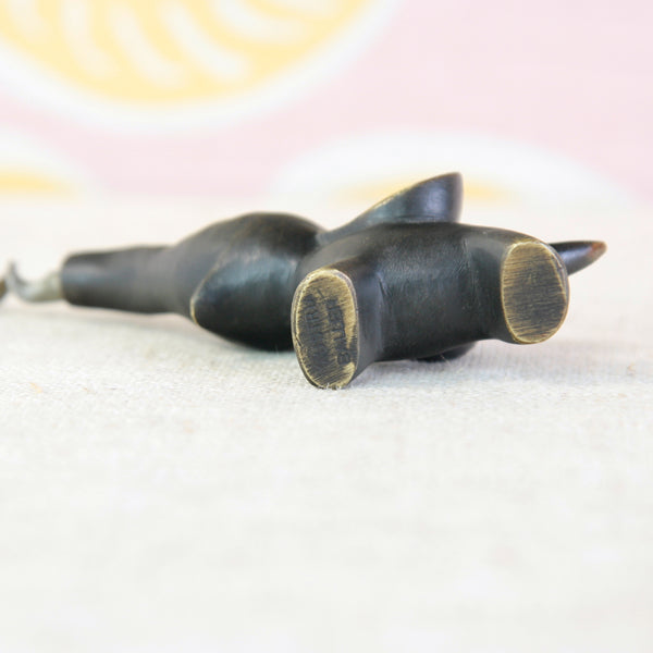 Underside of Playful baby elephant corkscrew designed by Walter Bosse, with large ears and an outstretched trunk, stamped "Baller Austria".
