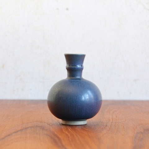 Head on shot of a unique Wilhelm Kage blue glazed bottle vase for Gustavsberg showing collared neck and refined garlic-neck silhouette inspired by East Asian ceramics. For sale in UK.