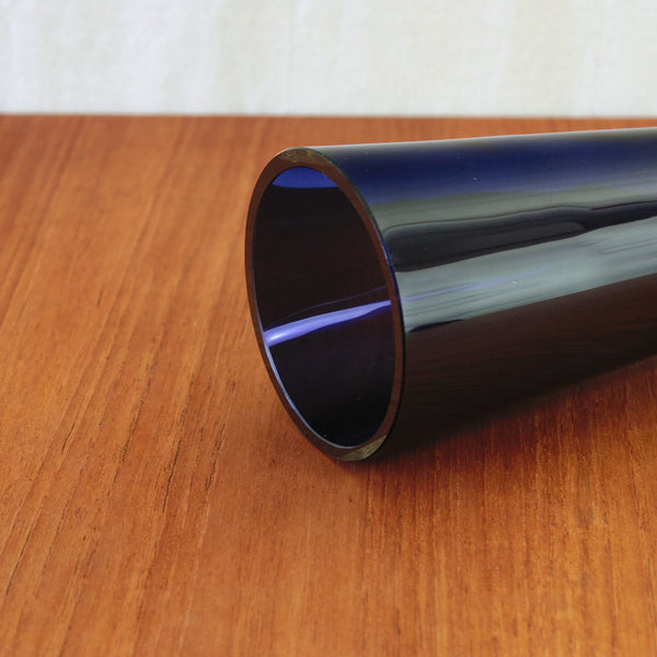 1960s Finnish studio glass vase by Unto Suominen, with a tall conical body in richly pigmented purple and a clear faceted foot.