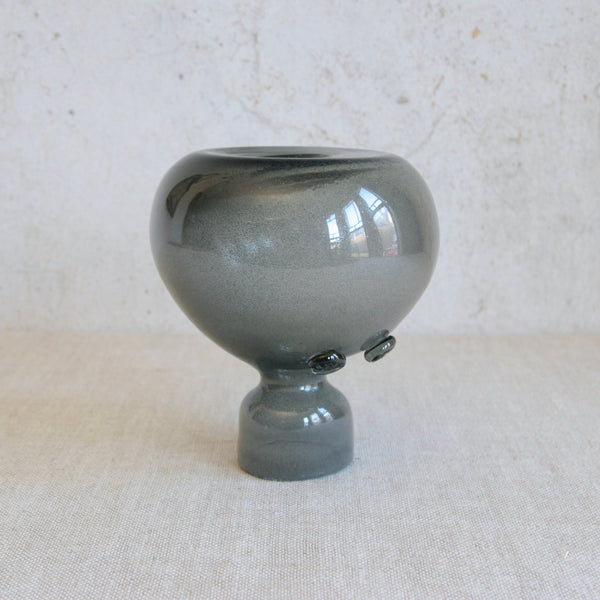 Playful image showing a sculptural woman-shaped vase upside down. Iridescent carborundum glass item designed by Erik Höglund at Boda, Sweden, showcasing postwar experimentation in Scandinavian studio and factory art glass.