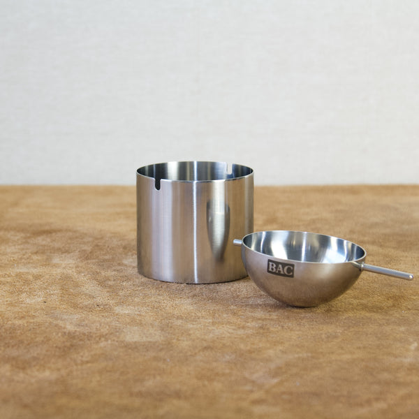 Arne Jacobsen stainless steel ashtray photographed against a clean studio backdrop
