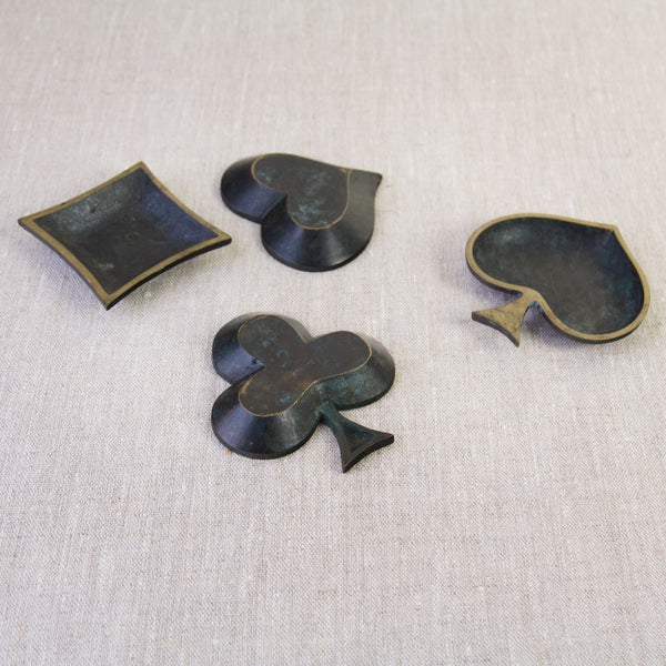 Midcentury modern set of four modernist brass ashtrays, shaped like suits from a deck of cards. Crafted in West Germany.