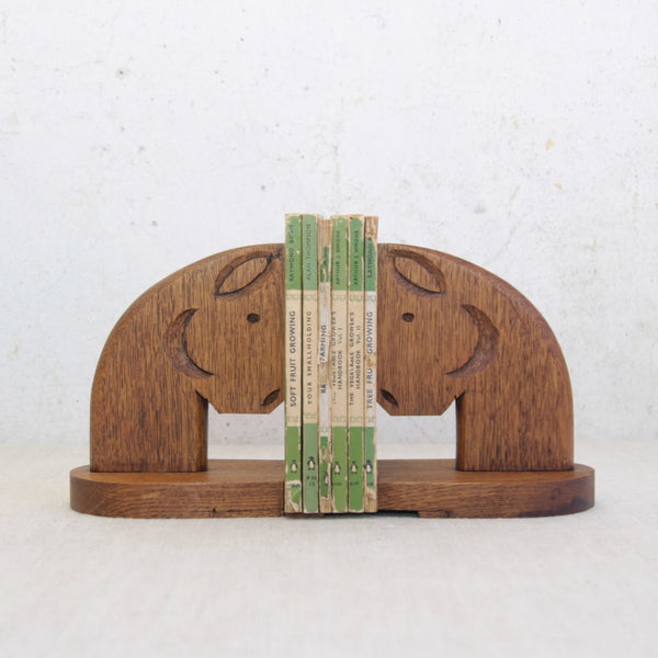 Mood image of a pair of one-off hand-carved oak horse bookends, British circa 1950, blending functional use with sculptural presence.