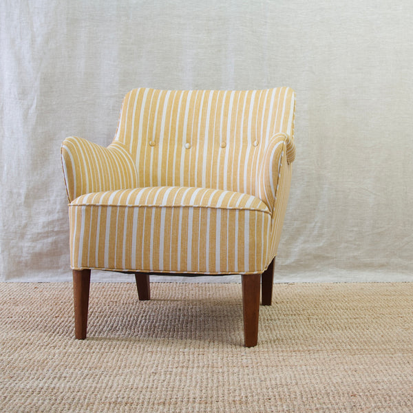 Low down image of Model 1748 lounge chair by Peter Hvidt & Orla Mølgaard-Nielsen for Fritz Hansen. The upholstery on the chair is Fermoie's York Stripe. Available as a pair from Nordic design gallery Art & Utility.