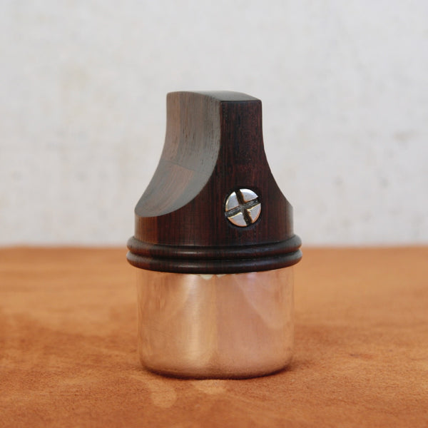 Detailed view of the silver-plated loading screw on a Jens Quistgaard pepper mill for Dansk Designs’ Rosewood & Silver range.