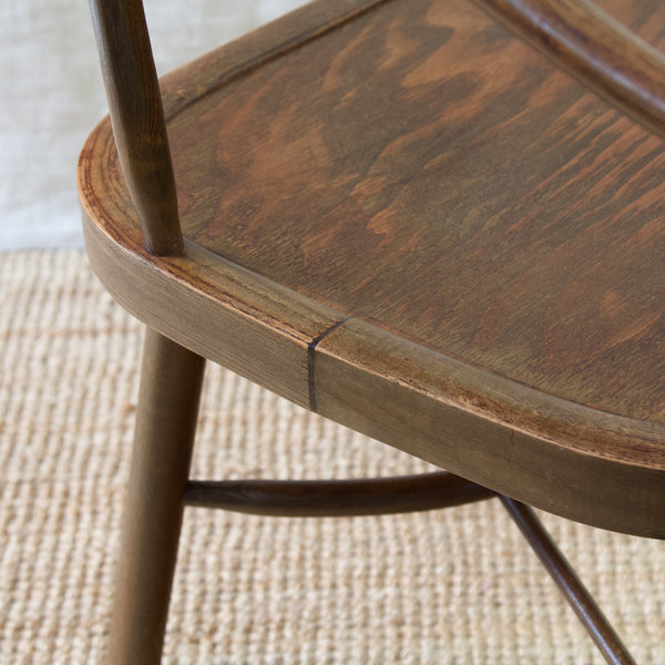 Invest in a Niels Eilersen Functionalist Windsor chair, a coveted collectible piece of Scandinavian design history.