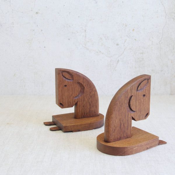 Handcrafted British oak horse bookends, mid-century period, expressing elegant form through restrained carving.