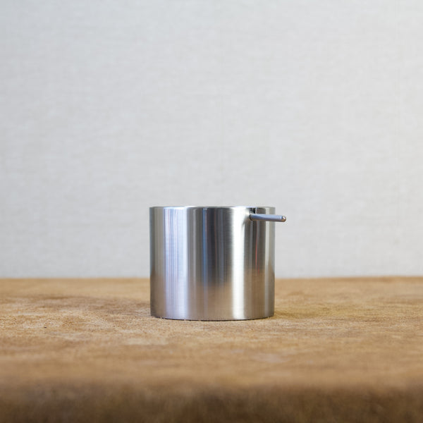 Stelton Danish Modern revolving ashtray with cylindrical base and balanced lid.