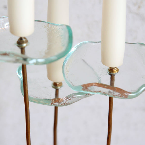 Top down view onto a unique vintage brass and glass candlestick, Nordic floral design from the 1960s.