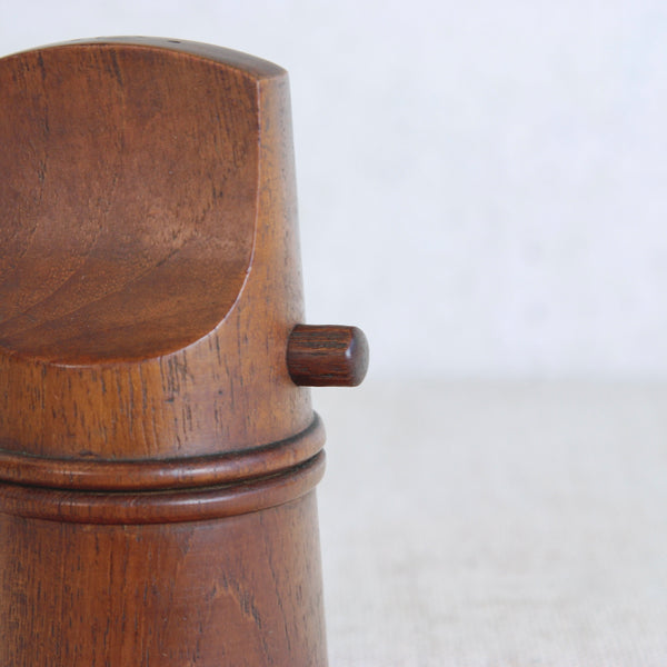 A highly collectible teak “flathead” pepper mill by Jens Quistgaard for Dansk Designs, featuring bold form and Scandinavian minimalism.