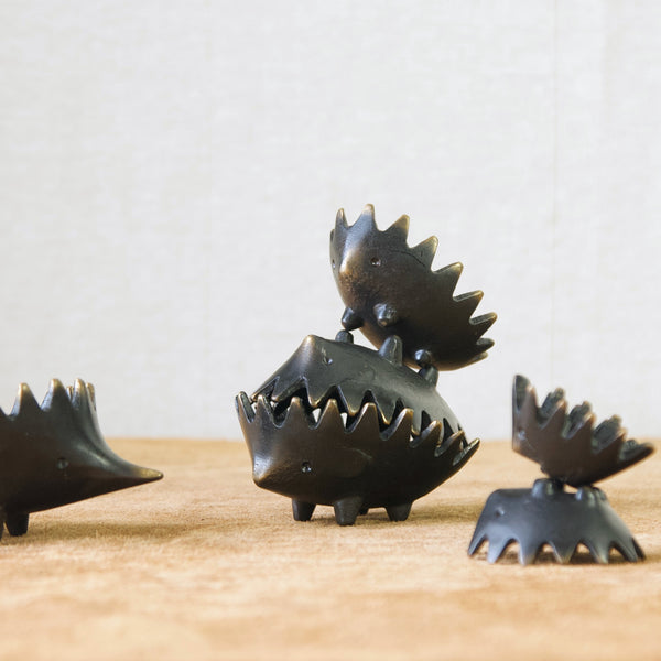 Family of six patinated brass hedgehog ashtrays designed by Walter Bosse, Austria 