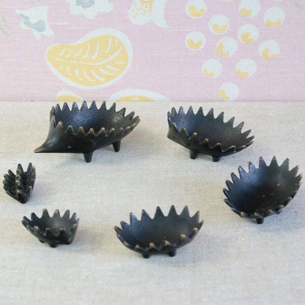 Original 1950s Walter Bosse stacking hedgehogs showing the characteristic black patination and contrasting golden polished brass details.
