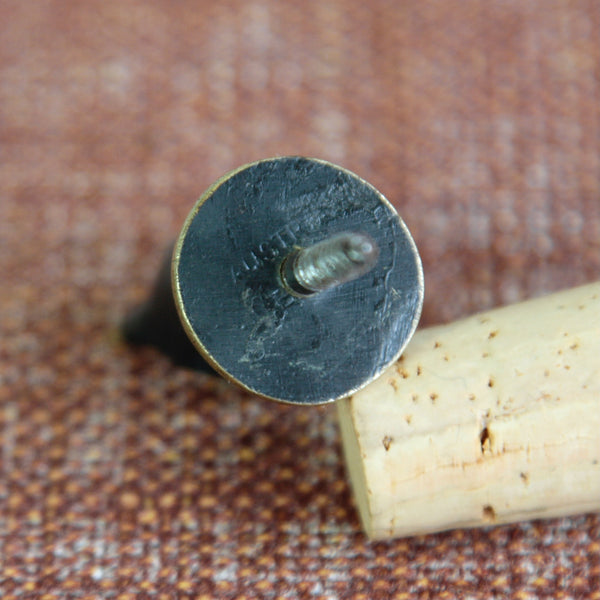 Detail of stamped underside showing makers marks on a Walter Bosse brass owl bottle stopper, made by Herta Baller, c.1950. Charming mid-century modern bar accessories by the Viennese duo Bosse & Baller are highly collectible.
