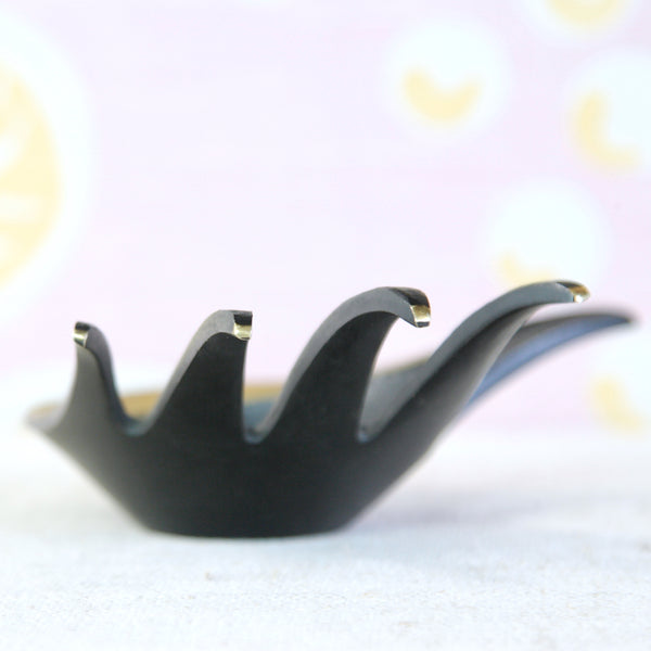 Vintage Walter Bosse hand ashtray in black and golden brass, an elegant example of Austrian mid-century design.