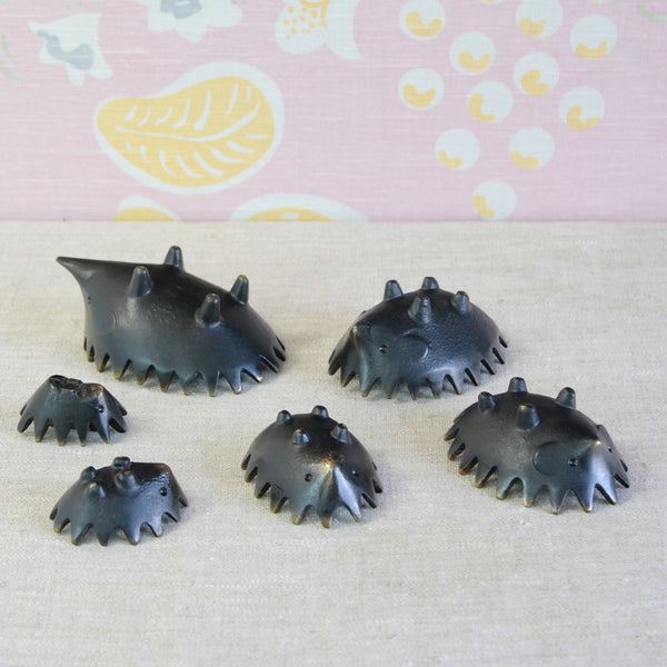 Family of six Modernist brass hedgehog ashtrays by Austrian designer Walter Bosse, each graduating in size from the smallest to the largest.